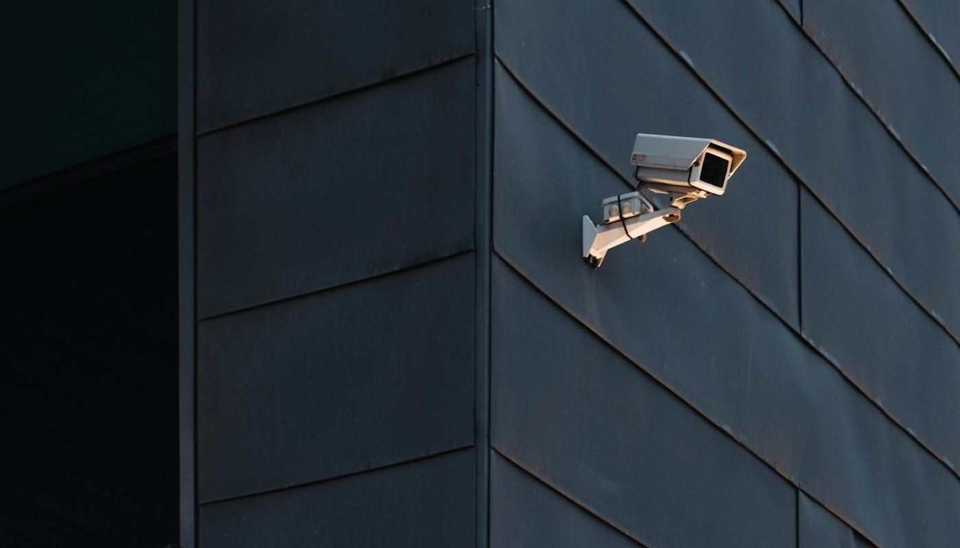 CCTV cameras mounted on a dark office facade
