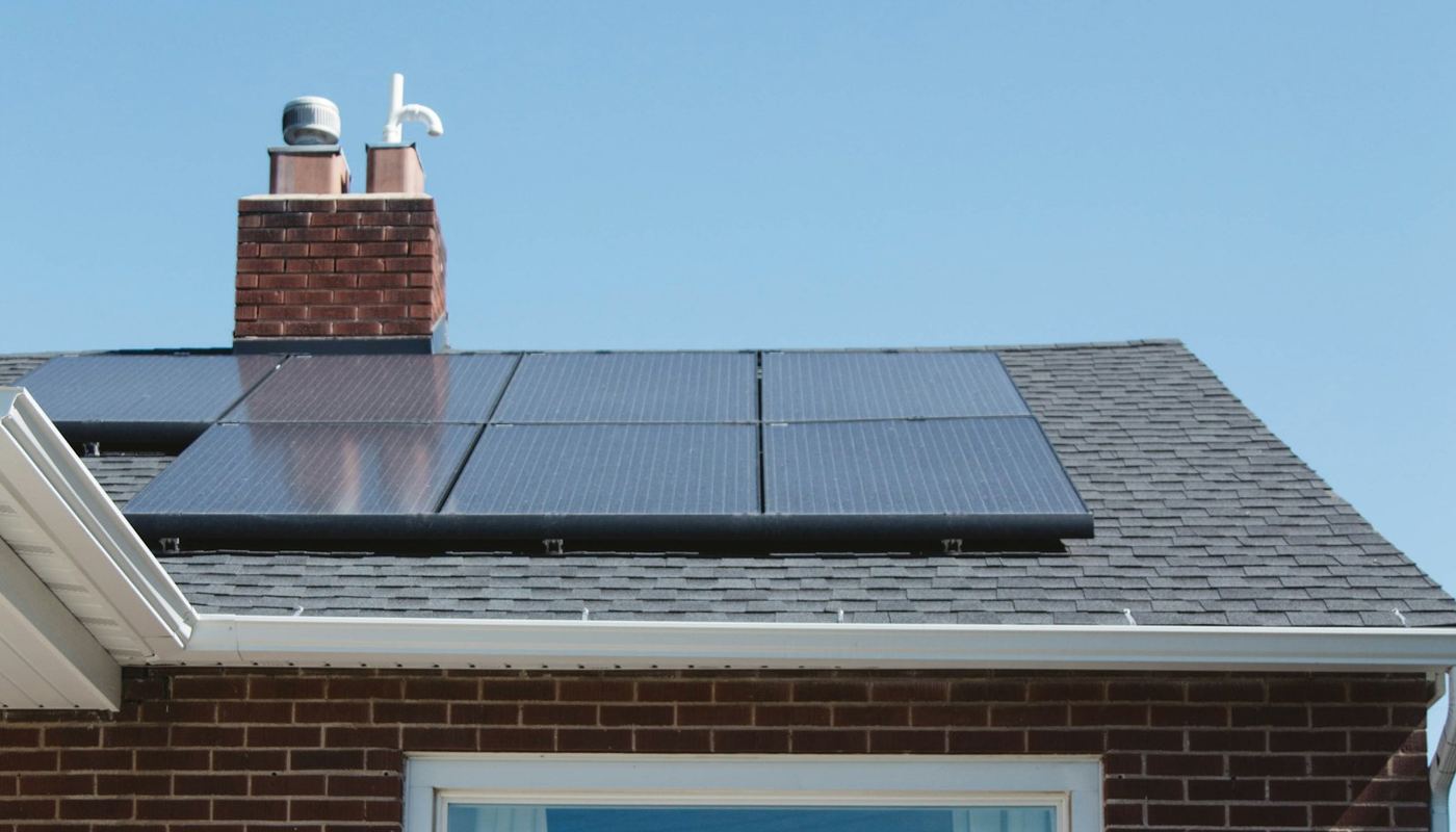 All-black solar panels on the roof of a brick house