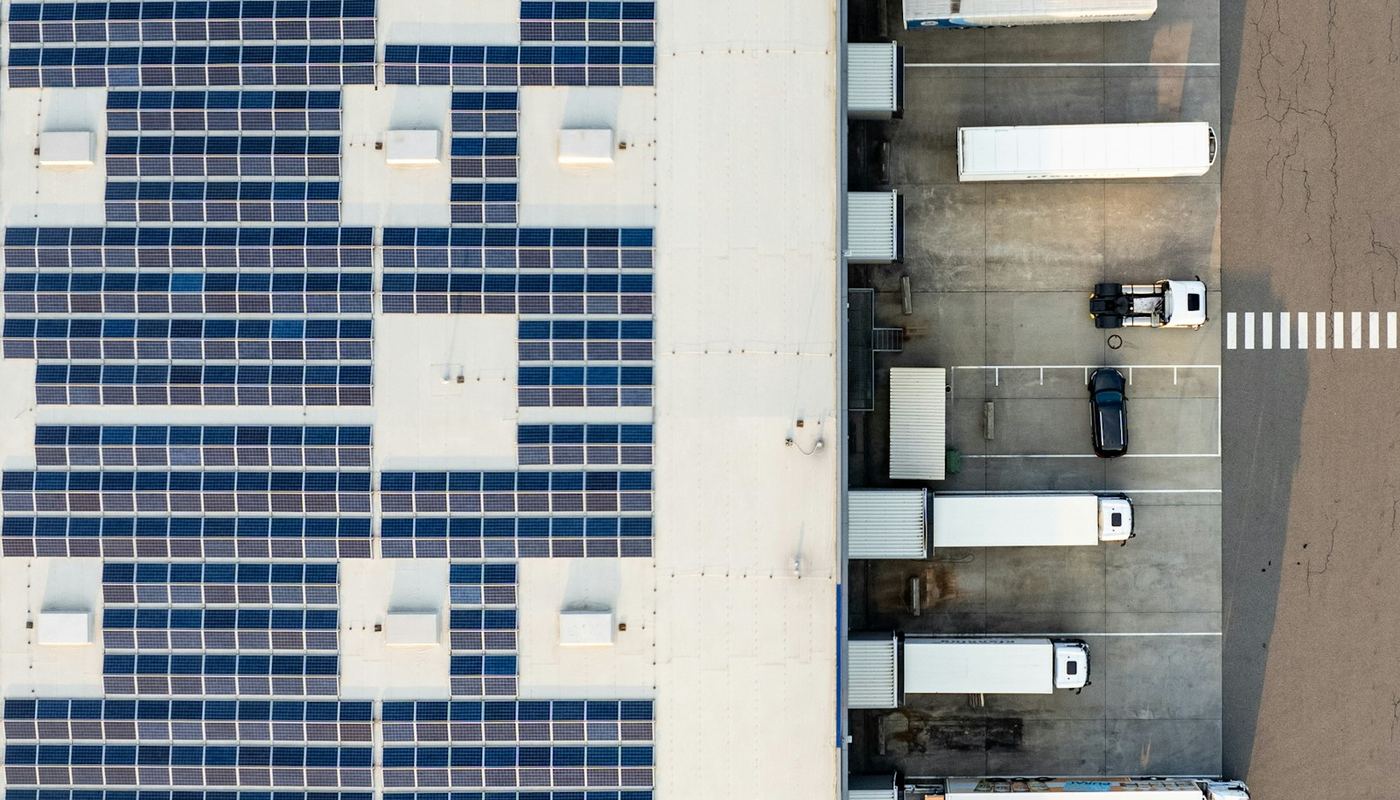 Aerial view of a distribution warehouse roof covered in solar panels